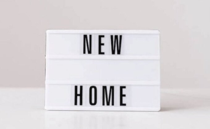 Image is showing a rectangular light box emblazoned with the words NEW HOME.